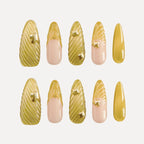 Chapter Gold 3D Press-on Nails (Almond, Long) with gold and pink designs: nails feature 3D gold swirl textures (some with small gold accents) and pink bases with gold 3D details (e.g., shell-like patterns).