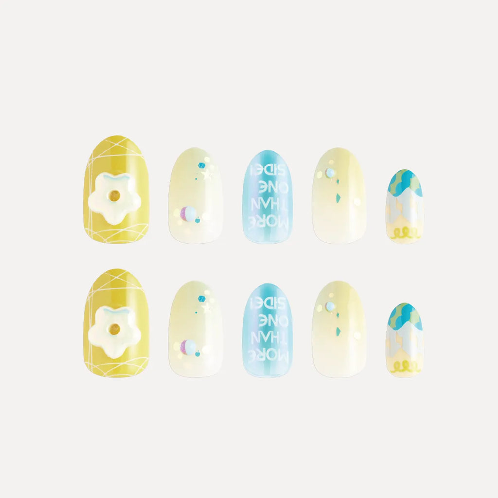 Blossom Mirror 3D press-on nails (round, medium length) featuring designs: yellow base with white flower/grid, light yellow with colorful dots/balls, blue with reversed text, and blue-yellow gradient with pattern. Two matching sets displayed.