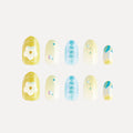 Blossom Mirror 3D press-on nails (round, medium length) featuring designs: yellow base with white flower/grid, light yellow with colorful dots/balls, blue with reversed text, and blue-yellow gradient with pattern. Two matching sets displayed.