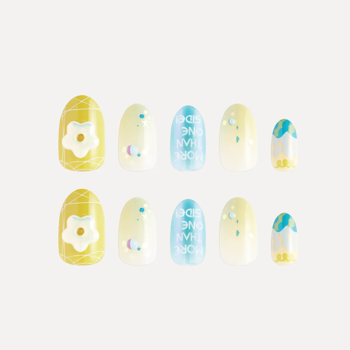 Flat lay of yellow and blue decorative press-on nails with 3D flower charm and gradient patterns.