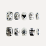 Flat lay of 10 Chrome Vision short square press-on nails featuring silver chrome textures, handwritten text graphics, heart motif, star accents, and 3D metallic studs.