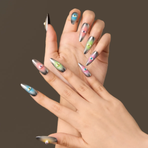 Hands wearing the “Cosmic Vigil” long almond press-on nails featuring chrome silver bases with multi-color gradient eye motifs in pink, blue, green, and yellow.