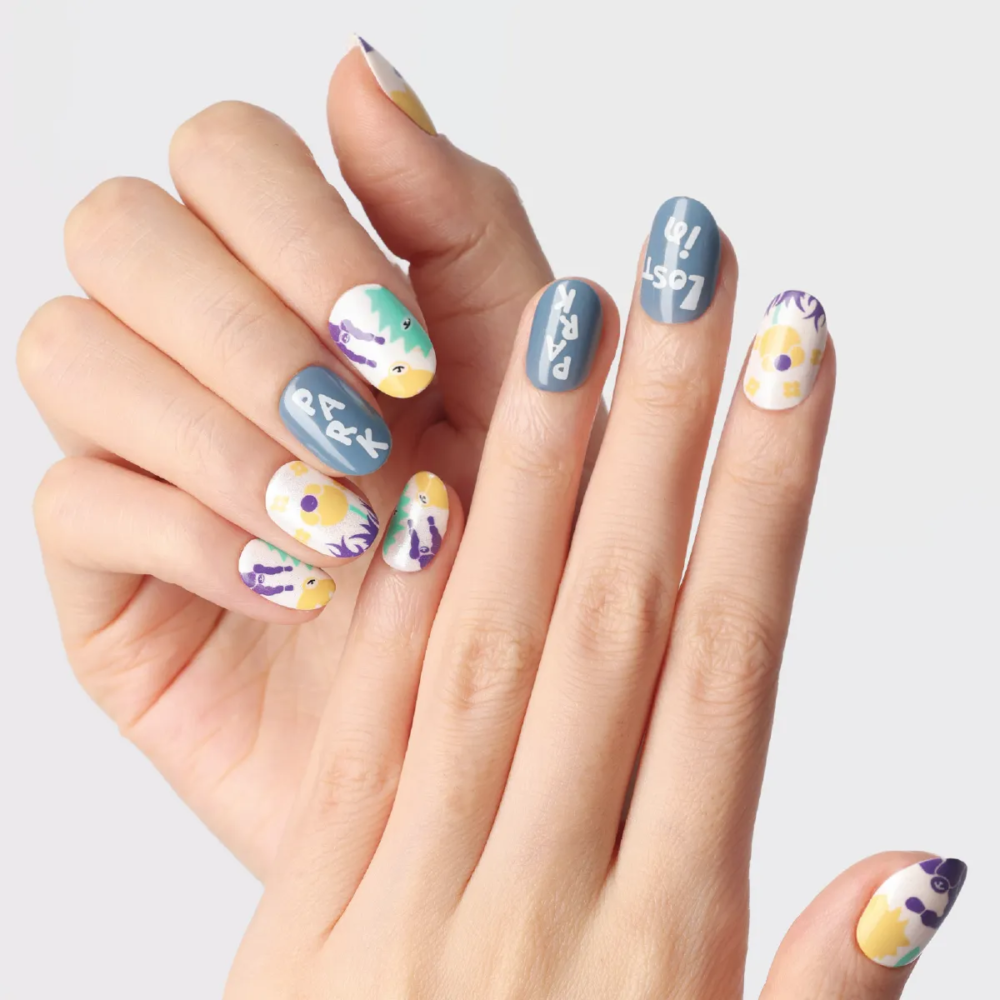 Full hand look of Day Dreaming press-on nails featuring blue “LOST in PARK” lettering and playful multicolor floral graphics