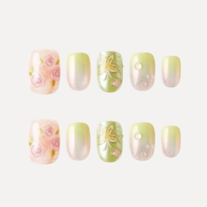 Flat lay of Dewy Garden press-on nail tips featuring pink roses, green floral embossing, and shimmering gradient designs