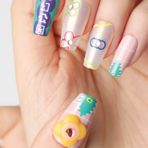 Close-up of Flower Bazaar press-on nails featuring 3D yellow flower charm and colorful outlined graphics