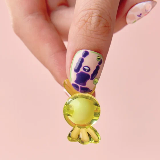 Close-up of thumb showcasing bold color press on nail