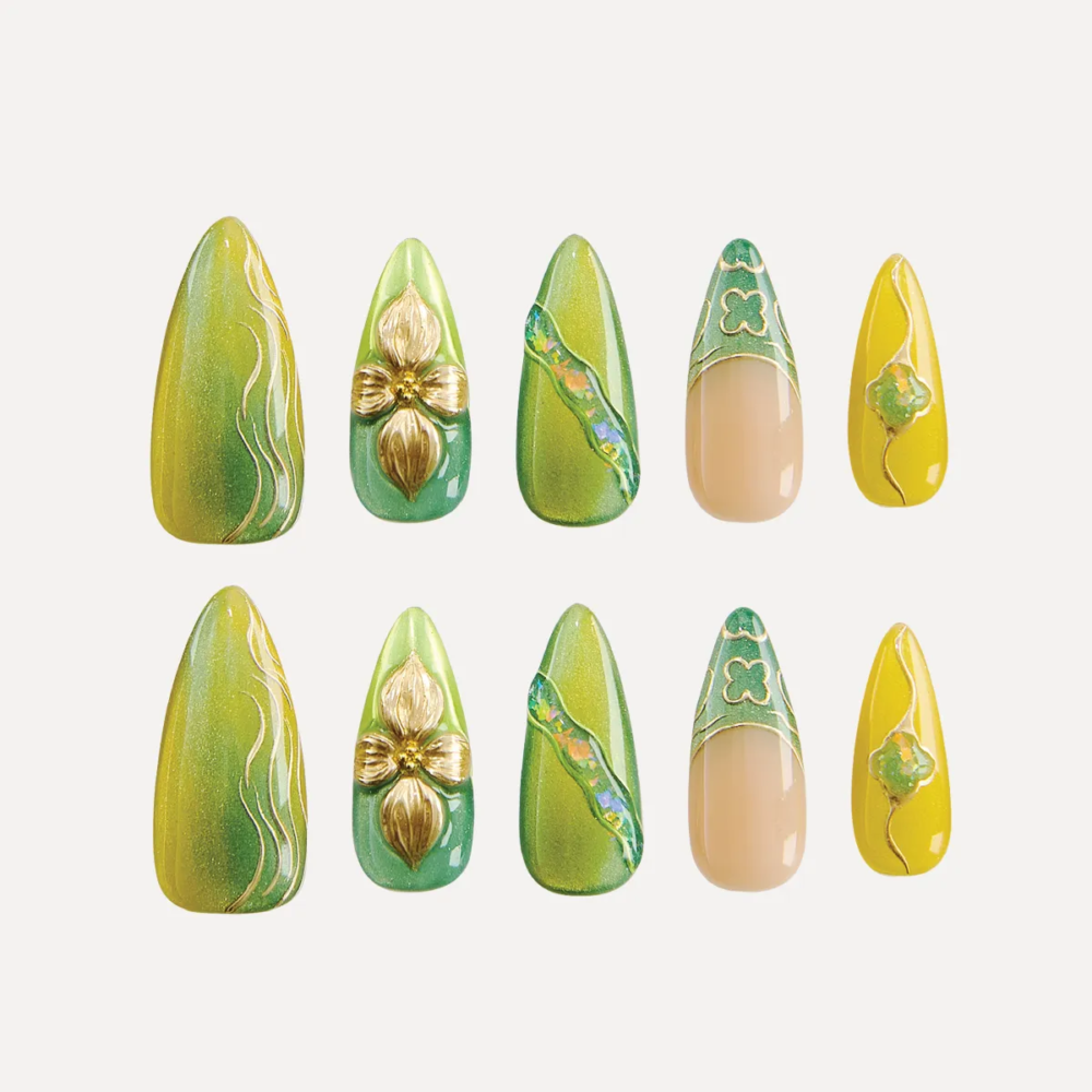 Flat lay of 10-piece Jade Gleam press-on nail set in green, gold, and yellow with 3D details