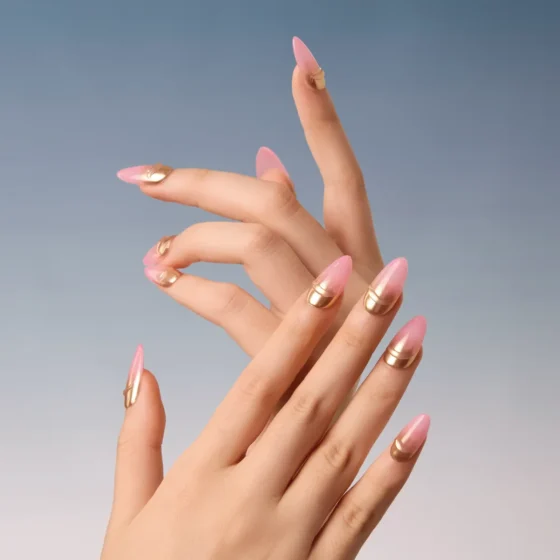Graceful hand pose showing full Jelly Wink press-on nail set in pink and gold gradient