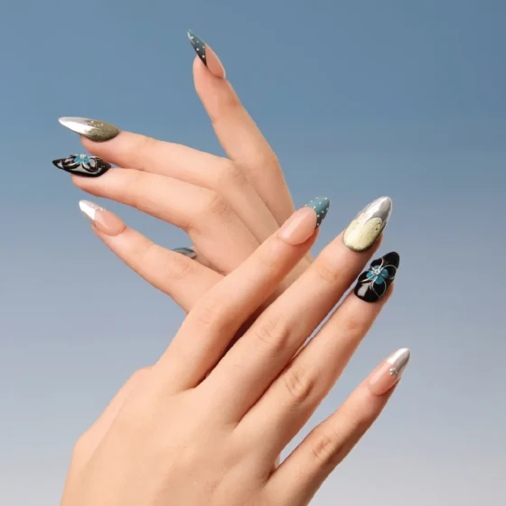 Artistic hand pose wearing Midnight Reverie press-on nails in cool tones with bold textures.
