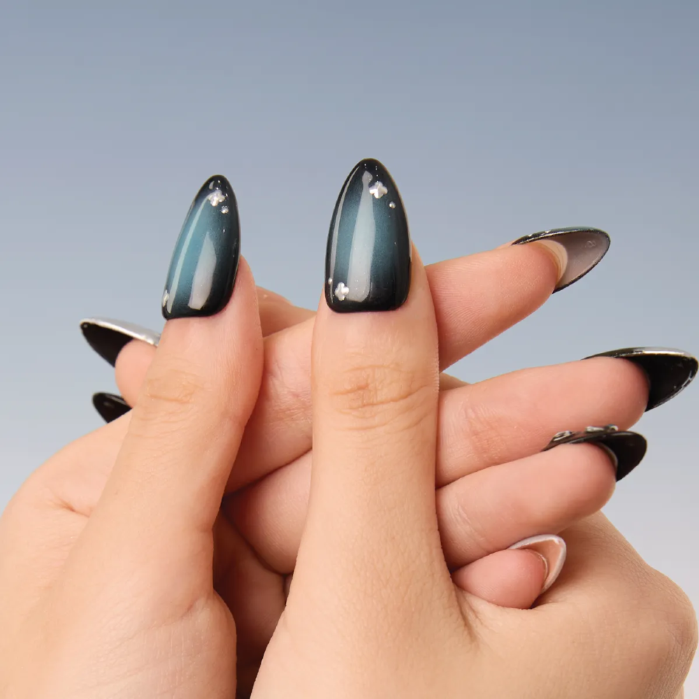 Elegant display of Midnight Reverie press-on nails featuring metallic accents and layered shine.