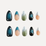 Flat lay of Midnight Reverie nail set with glossy midnight blue, dotted green chrome, and floral black designs.