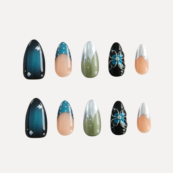 Flat lay of Midnight Reverie nail set with glossy midnight blue, dotted green chrome, and floral black designs.