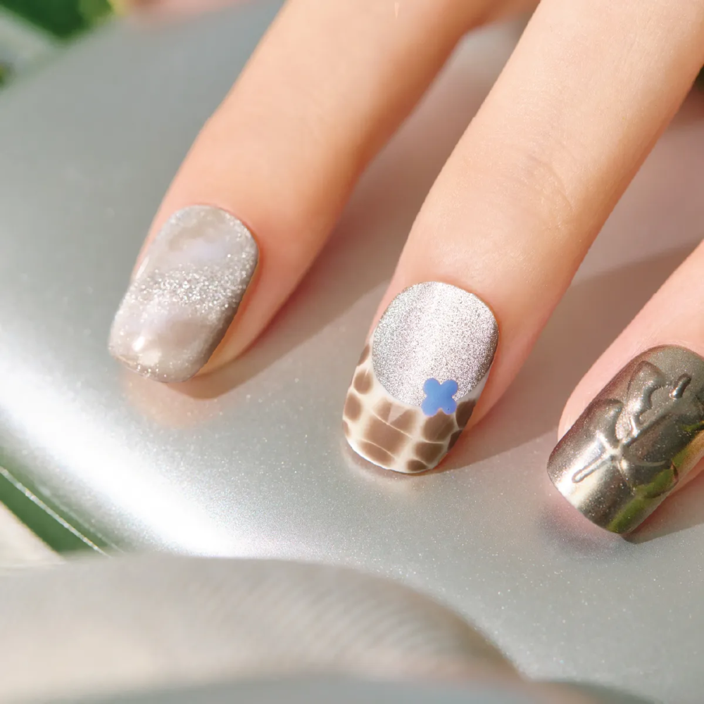 Macro shot of LOST in PARK Mocha Mirage nail – metallic, textured and glossy finish