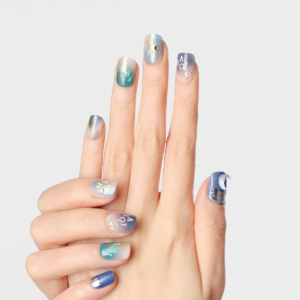 Full hand view of press-on nails with celestial theme, featuring text and metallic accents