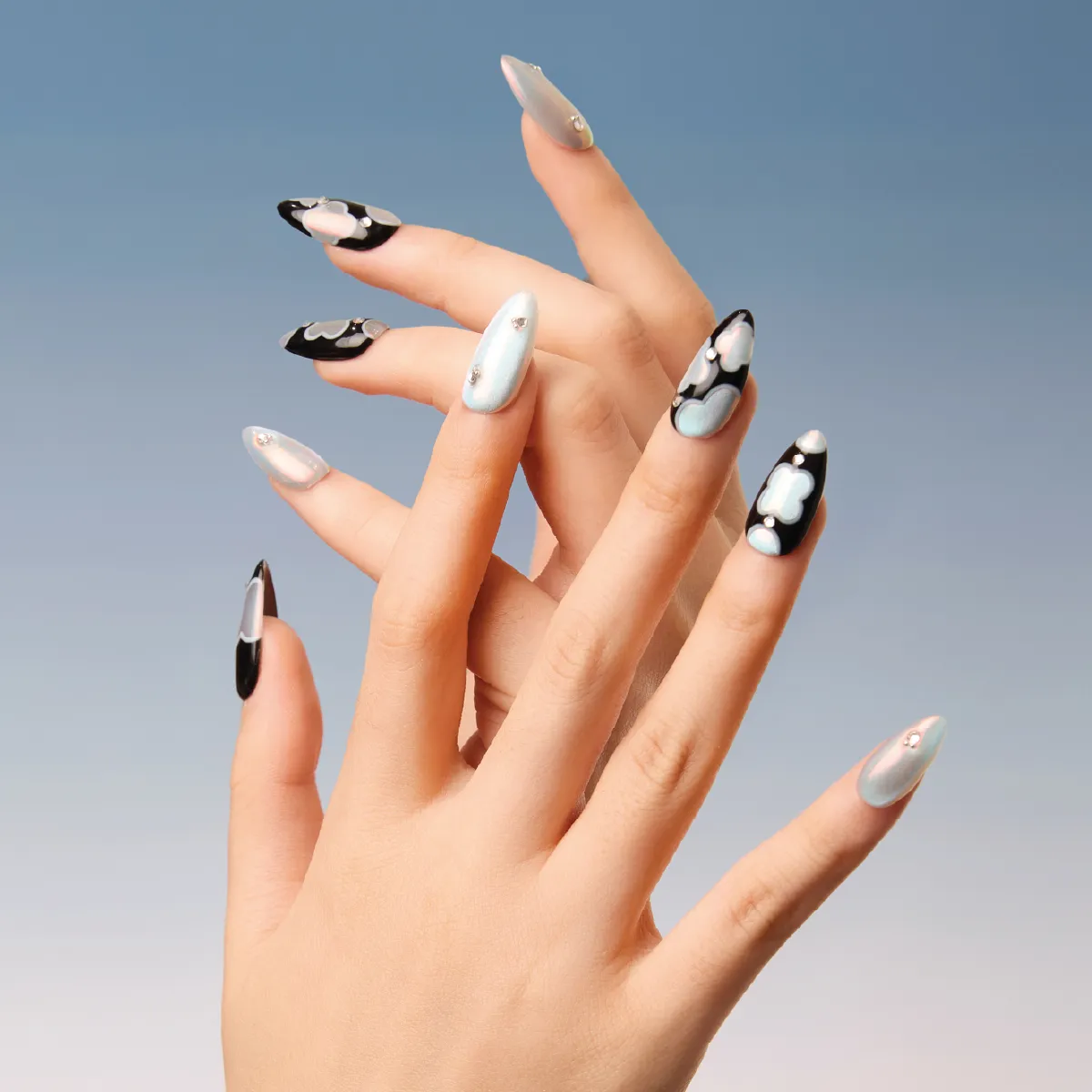 Hand model wearing LOST in PARK Phantom Bloom press-on nails with cloudy shimmer design