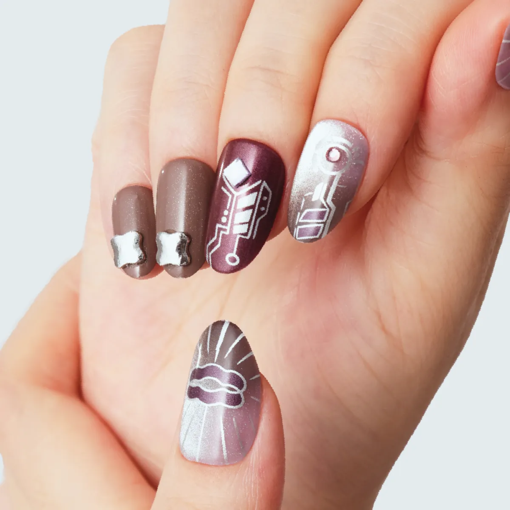 Close-up of sci-fi themed press-on nails with chrome lips and abstract line art