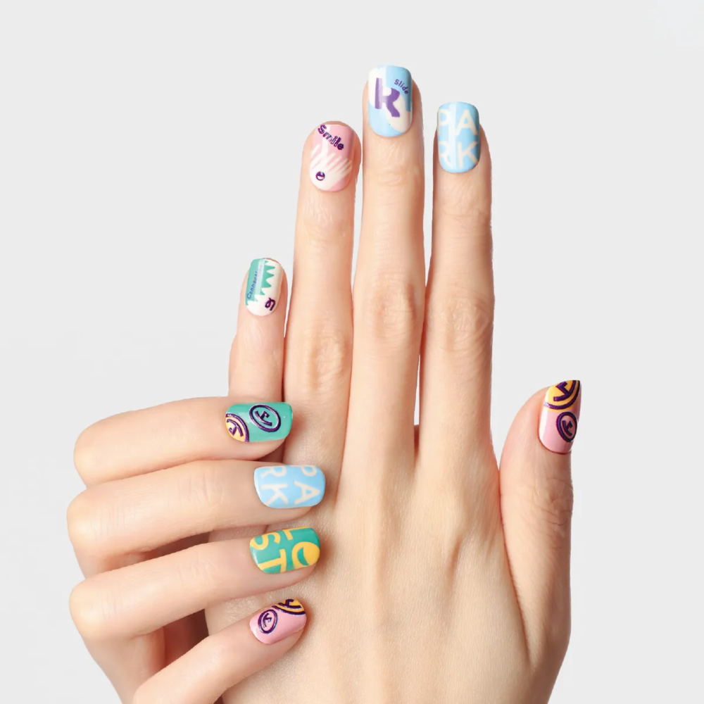 Front-facing hand pose highlighting the LOST in PARK text and graphic nail art from Riotous Paradise