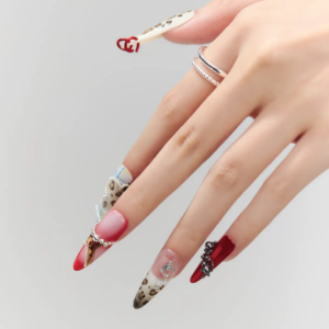 Close-up of Rouge Leopard press-on nails featuring 3D hearts, plaid patterns, and glitter details