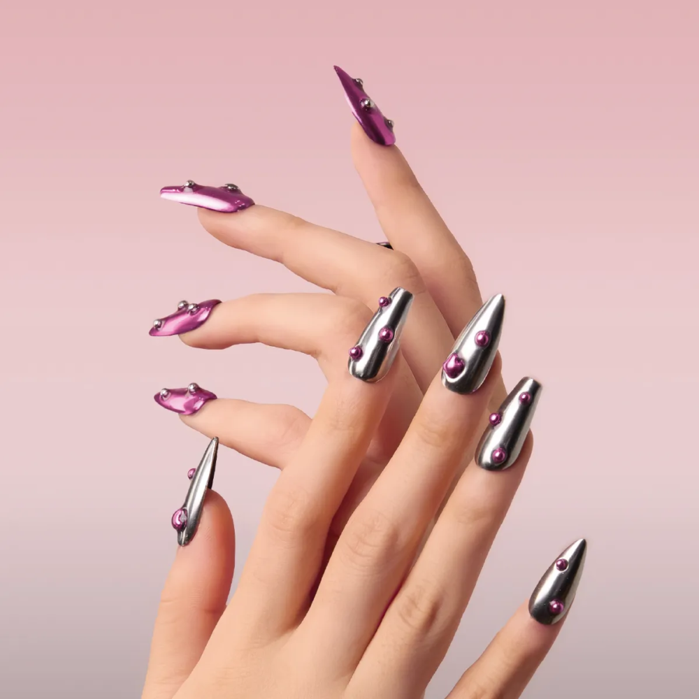 Close-up of chrome press-on nails in silver and candy pink, featuring raised bubble accents