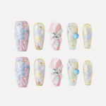 Full Sweet Dream Bomb nail set (10 pieces) laid flat showing pastel designs, 3D hearts, and gem embellishments.