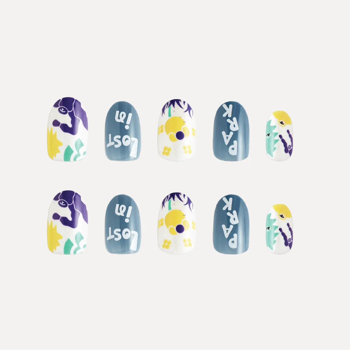 Flat lay of Day Dreaming press-on nail tips featuring blue lettering, yellow florals, and abstract purple and green illustrations