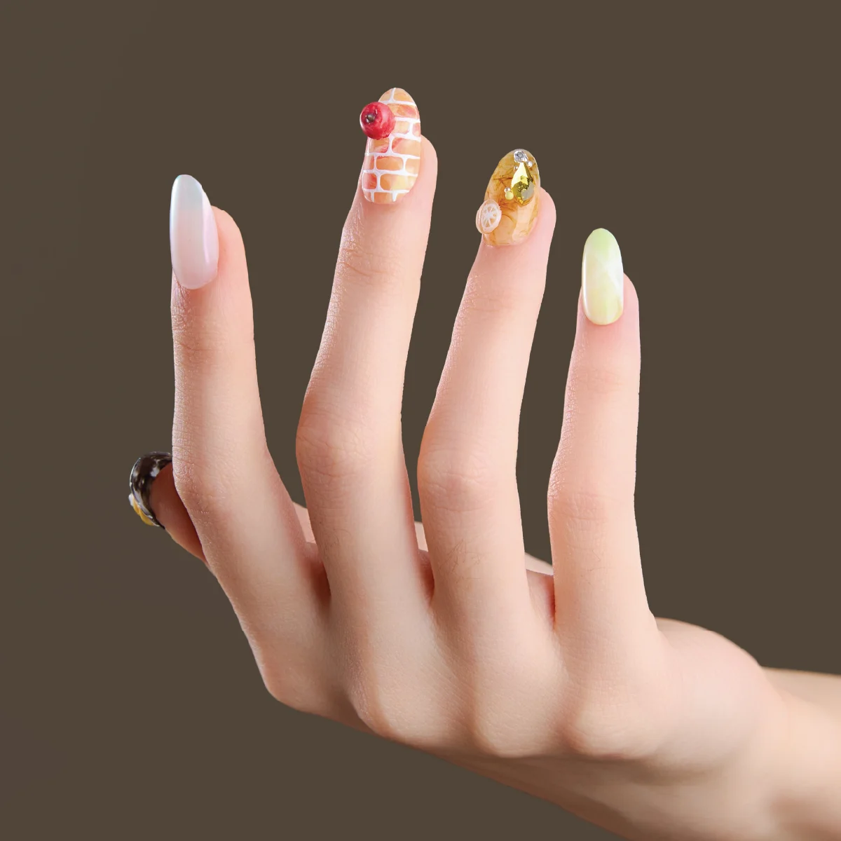 Front view of Miss Glimmerhood short oval press-on nails worn on hand