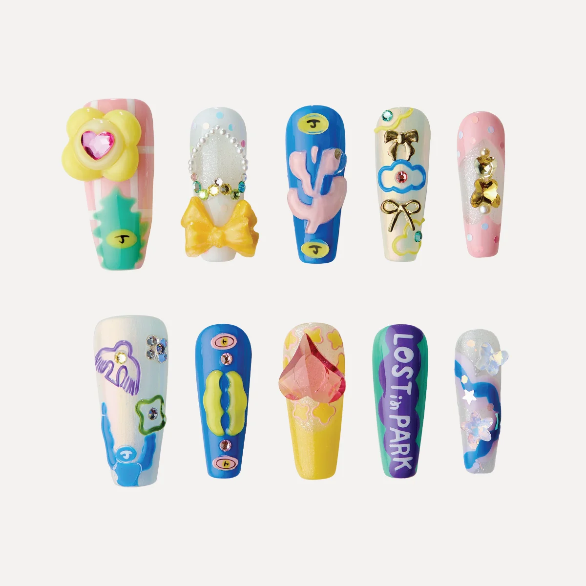 Playground press-on nails with colorful graphics, playful charms, and bold sculptural designs