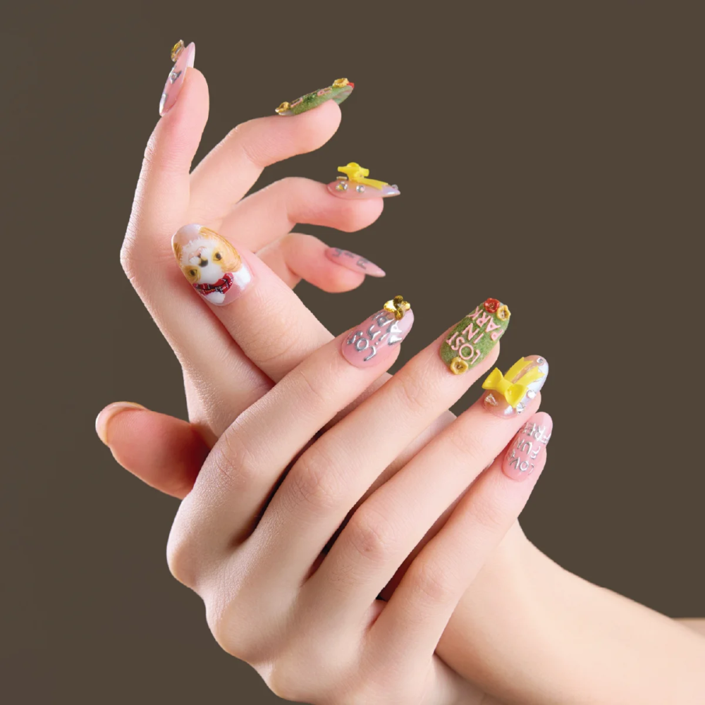 Short oval press on nails with cute character and bow details shown in dynamic hand pose