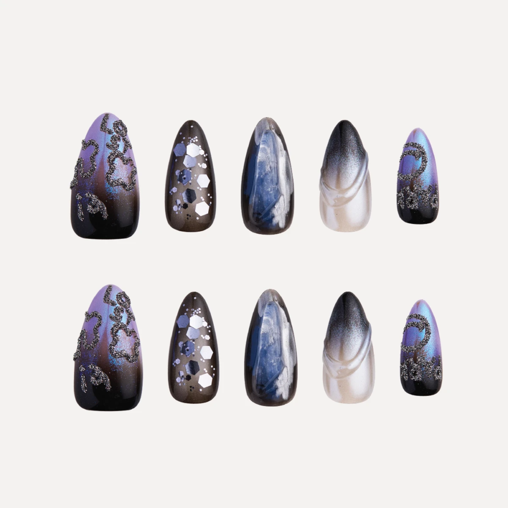 Mystic Jewel medium almond press-on nail set with galaxy-inspired blue, black and silver designs