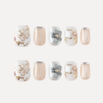 Serene Pearl press-on nail set flat lay with floral, pearl, and nude shimmer designs