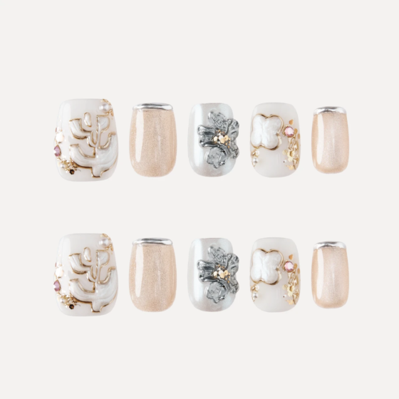 Serene Pearl press-on nail set flat lay with floral, pearl, and nude shimmer designs