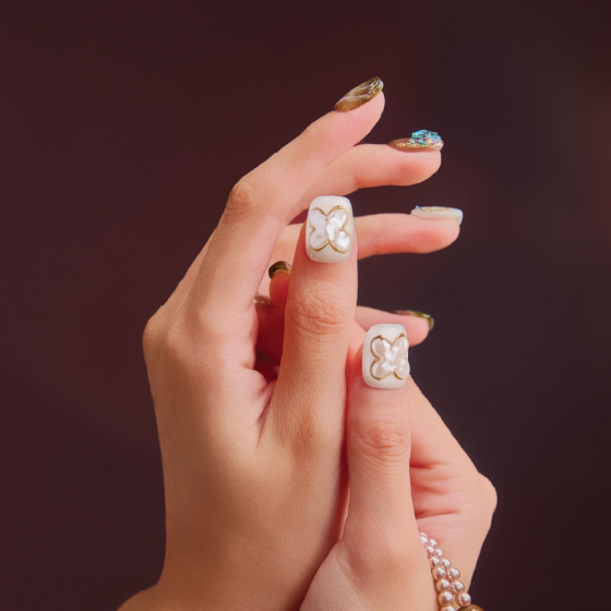 Close-up of Sunlight Opal press-on nail details on fingers