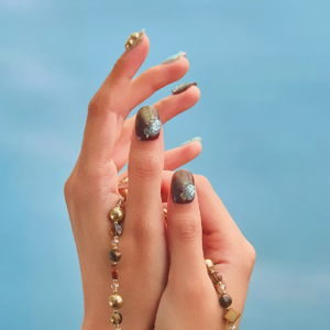 Short round press-on nails close-up with botanical green details